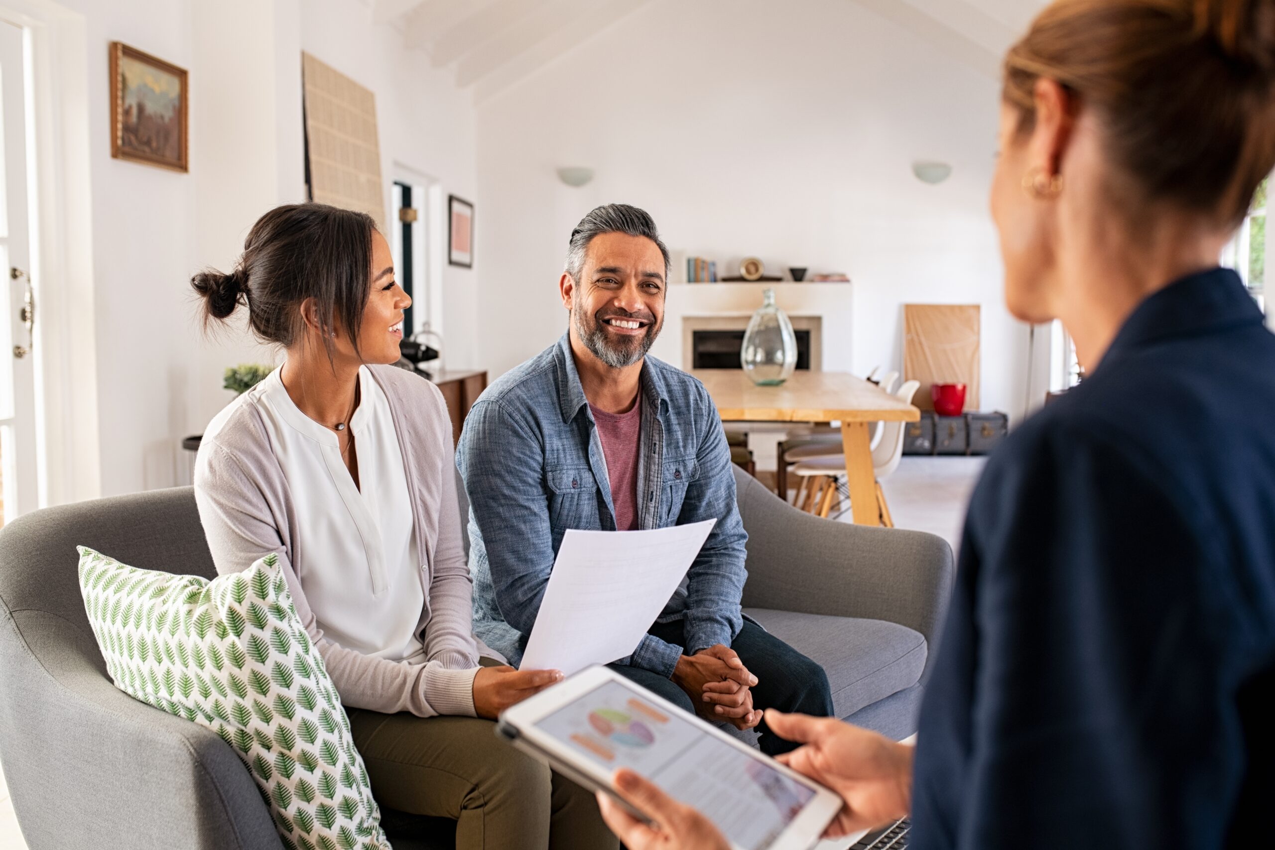 Happy,Mature,Couple,Discussing,Investments,With,Financial,Broker,During,Meeting